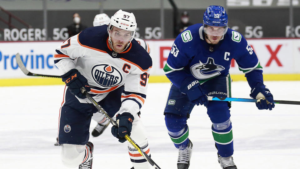 Connor McDavid, left, and Bo Horvat, right, are on fire to start the 2022-23 NHL season. (Photo by Jeff Vinnick/NHLI via Getty Images)