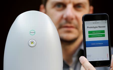 Aryballe Technologies CEO Tristan Rousselle shows a prototype of NeOse, a universal portable odour detection device connected to a database on a mobile phone, in Paris, April 20, 2016. REUTERS/Christian Hartmann