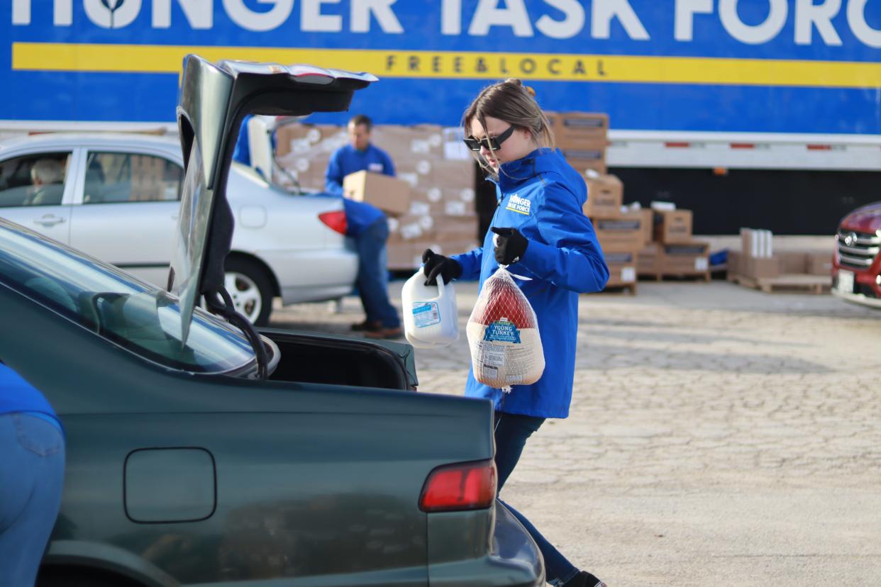 A turkey is placed in the trunk of a car in Milwaukee County, as part of the Hunger Task Force's food donation programs.