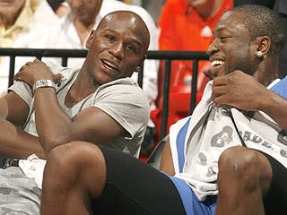 Floyd Mayweather hangs out with NBA star Dwyane Wade on Sunday in Miami at the Summer Groove All-Star Basketball Game. Money declined to talk boxing with a reporter