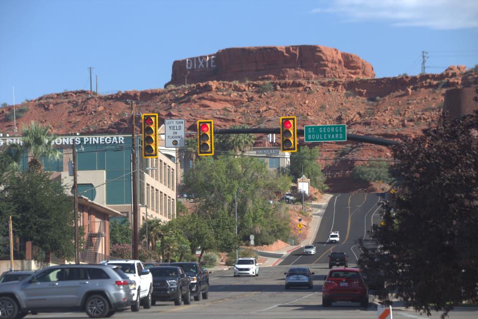 Traffic rolls past the intersection of 200 East and St. George Blvd. in St. George, beneath the "Dixie" Sugarloaf rock downtown. Despite record-high gas prices, forecasters are expecting heavy traffic for the Thanksgiving holiday this week.