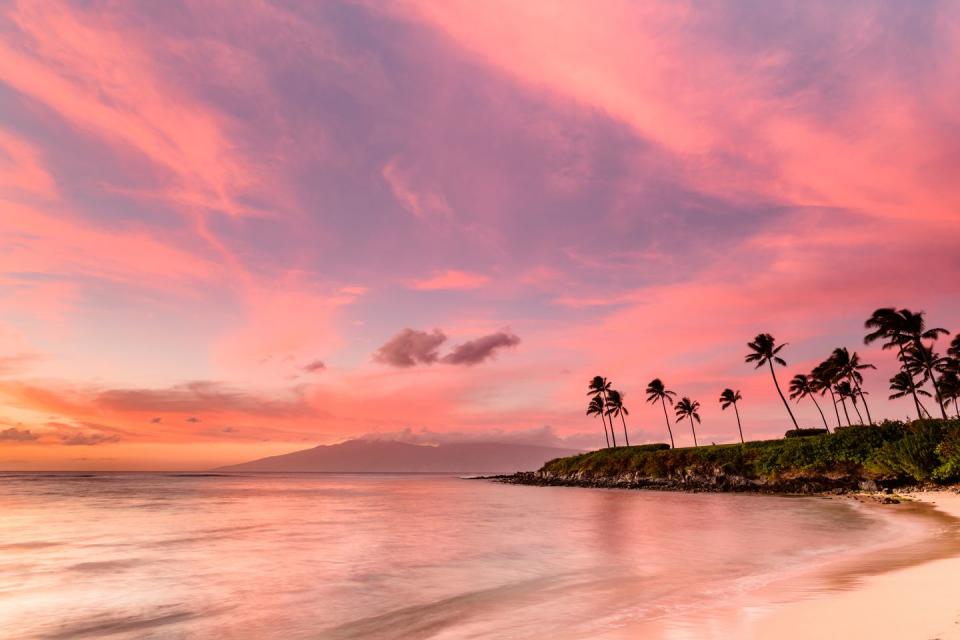 <p>A pink sky at sunset at Kapalua Bay, Maui, Hawaii. </p>