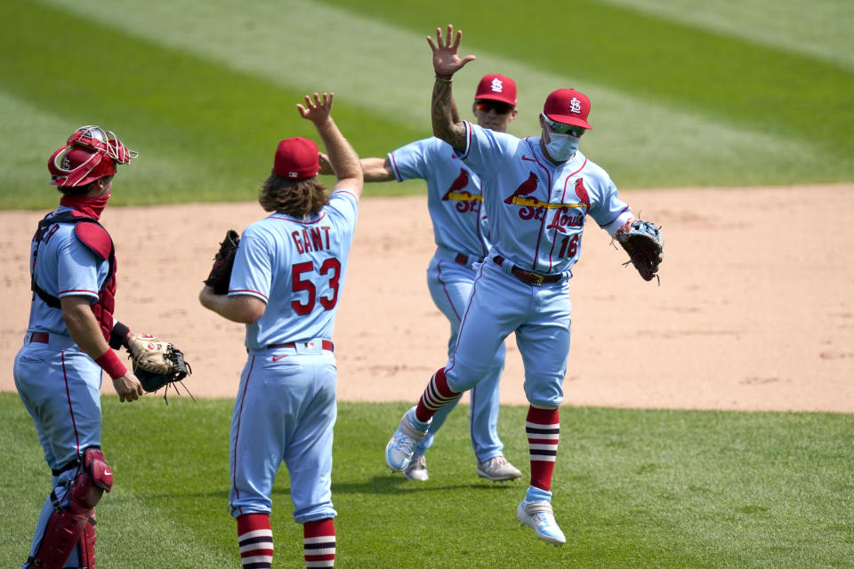 St. Louis Cardinals second baseman Kolten Wong (16) fakes a high five with relief pitcher John Gant (53) after the Cardinals 5-1 win over the Chicago White Sox in Game 1 of a double-header baseball game Saturday, Aug. 15, 2020, in Chicago. (AP Photo/Charles Rex Arbogast)