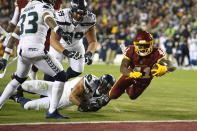 Washington Football Team running back J.D. McKissic (41) breaks aways from Seattle Seahawks middle linebacker Bobby Wagner (54) to score a touchdown during the second half of an NFL football game, Monday, Nov. 29, 2021, in Landover, Md. (AP Photo/Nick Wass)