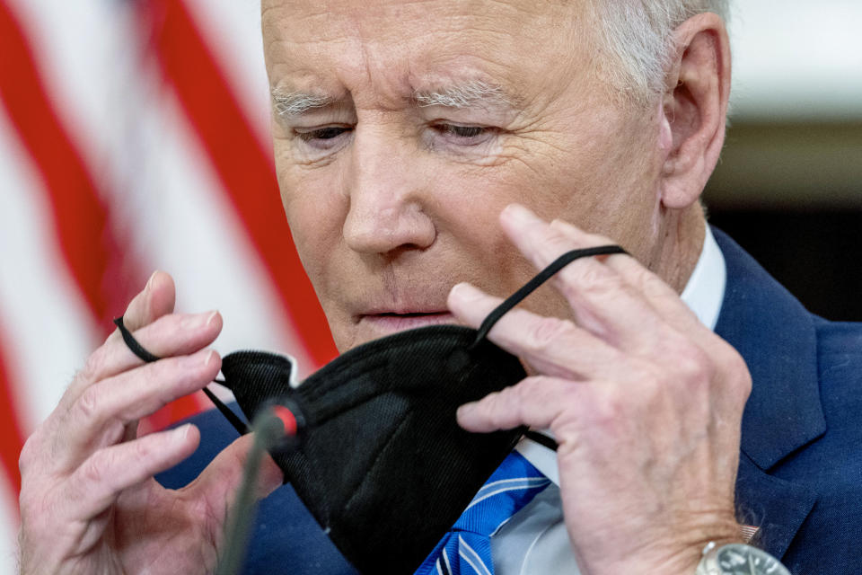 President Joe Biden puts his mask back on after speaking during a meeting with private sector CEOs about the economy in the State Dining Room of the White House in Washington, Wednesday, Jan. 26, 2022. (AP Photo/Andrew Harnik)