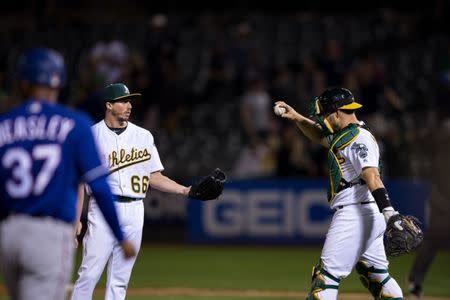 Apr 23, 2019; Oakland, CA, USA; Oakland Athletics relief pitcher Ryan Dull (66) and catcher Josh Phegley (19) celebrate their win over the Texas Rangers at Oakland Coliseum. Mandatory Credit: John Hefti-USA TODAY Sports