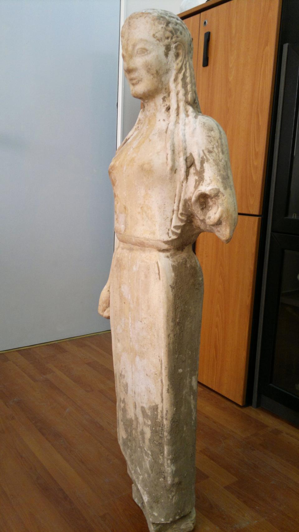 A 2,500-year-old statue of a young woman that was illegally excavated and hidden in a goat-pen near Athens is seen in this undated police handout photo released on Wednesday, March 28, 2012. Officers arrested the goatherder and another man who were allegedly trying to sell the work for half a million euros ($667,000). A police statement said the marble statue dates to about 520 B.C. and belongs to the kore type. It is largely intact, lacking the left forearm and plinth. (AP Photo/Greek Police handout)