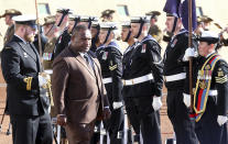 Papua New Guinea Prime Minister James Marape, second from left, inspects troops as he is officially welcomed to Australia's Parliament House in Canberra Monday, July 22, 2019. Marape says his country's relationship with China in not open to discussion during his current visit to Australia. (AP Photograph/Rod McGuirk)