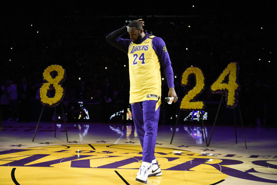 LeBron James looks down to regain his composure while speaking to the crowd in remembrance of Kobe Bryant before Friday night's game against the Portland Trail Blazers in Los Angeles. (AP Photo/Kelvin Kuo)