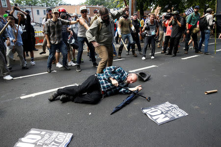 A man is down during a clash between members of white nationalist protesters and a group of counter-protesters in Charlottesville, Virginia, U.S., August 12, 2017. REUTERS/Joshua Roberts