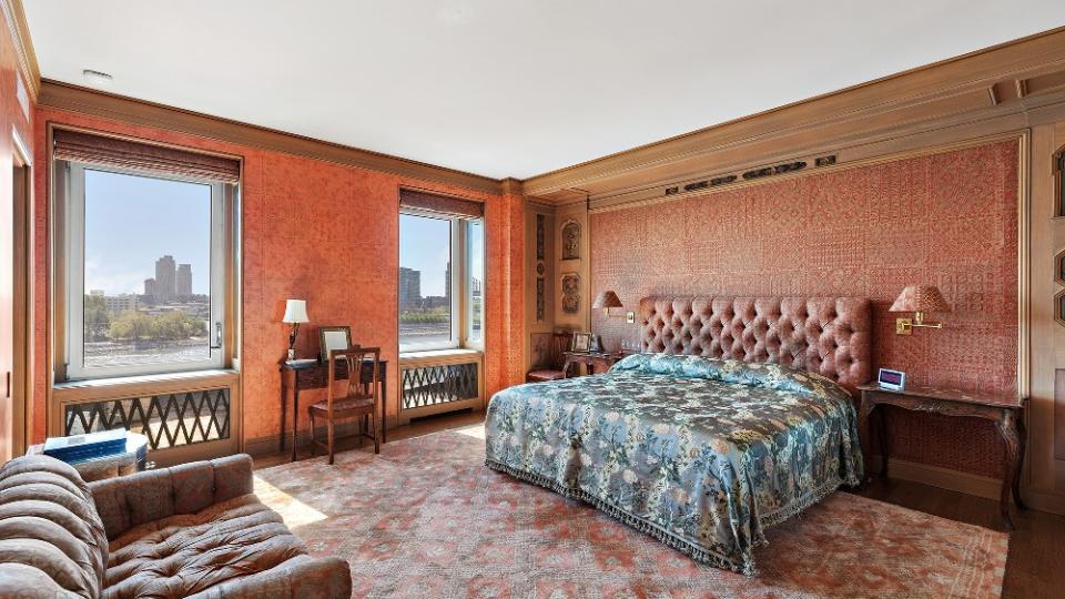 The primary bedroom with rose-colored Fortuny silk wall coverings and headboard - Credit: DDreps