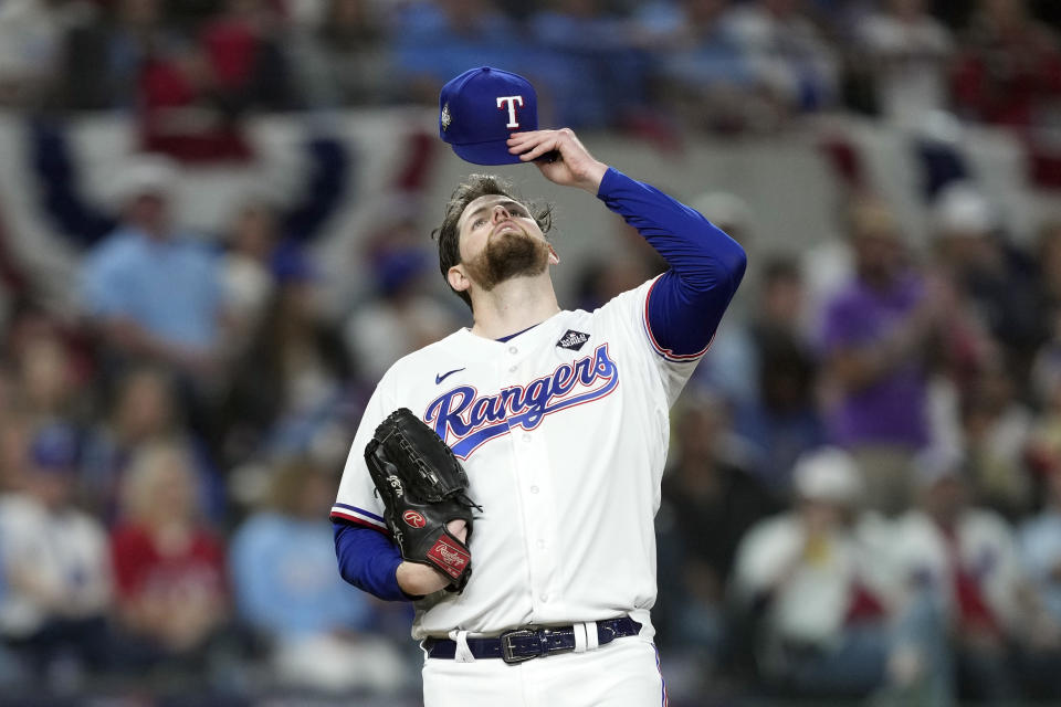 Texas Rangers starting pitcher Jordan Montgomery holds his hat after giving up a home run to Arizona Diamondbacks' Gabriel Moreno during the fourth inning in Game 2 of the baseball World Series Saturday, Oct. 28, 2023, in Arlington, Texas. (AP Photo/Godofredo A. Vásquez)