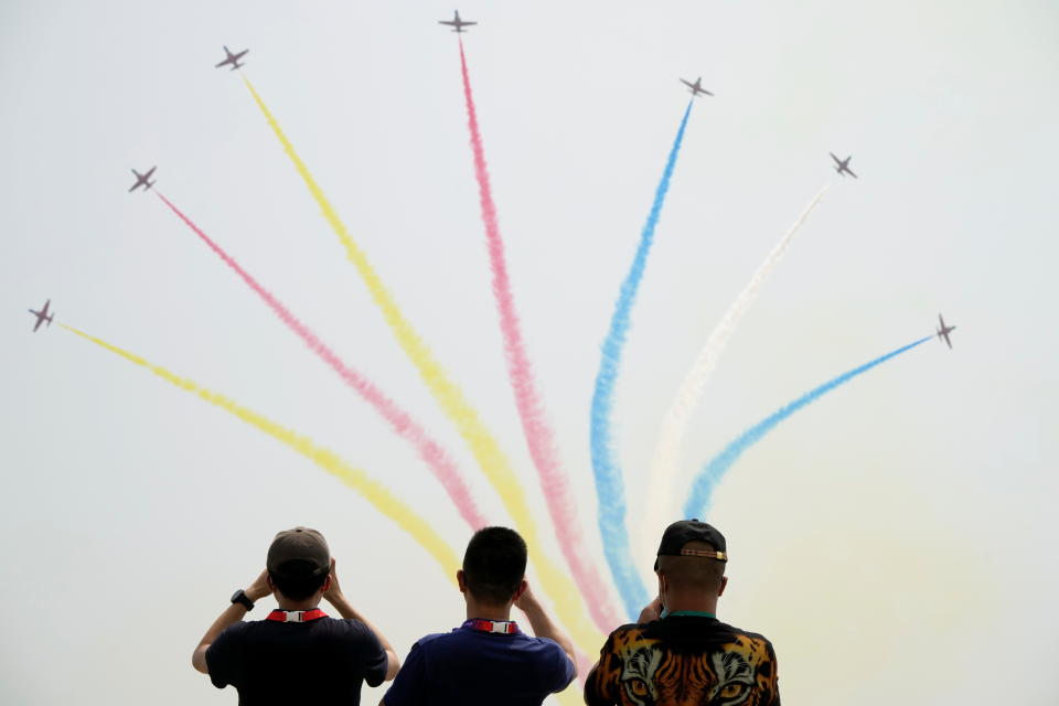 People watch Chinese People's Liberation Army (PLA) Air Force Red Falcon aerobatic team perform at the China International Aviation and Aerospace Exhibition, or Airshow China, in Zhuhai, Guangdong province, China September 28, 2021. REUTERS/Aly Song