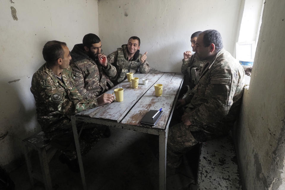 Ethnic Armenian soldiers take a rest near a fighting position on the front line, during a military conflict against Azerbaijan's armed forces in the separatist region of Nagorno-Karabakh, Wednesday, Oct. 21, 2020. Armenia's prime minister has urged citizens to sign up as military volunteers to help defend the country amid the conflict with Azerbaijan over the disputed territory of Nagorno-Karabakh as intense fighting has raged for a fourth week with no sign of abating. (AP Photo)