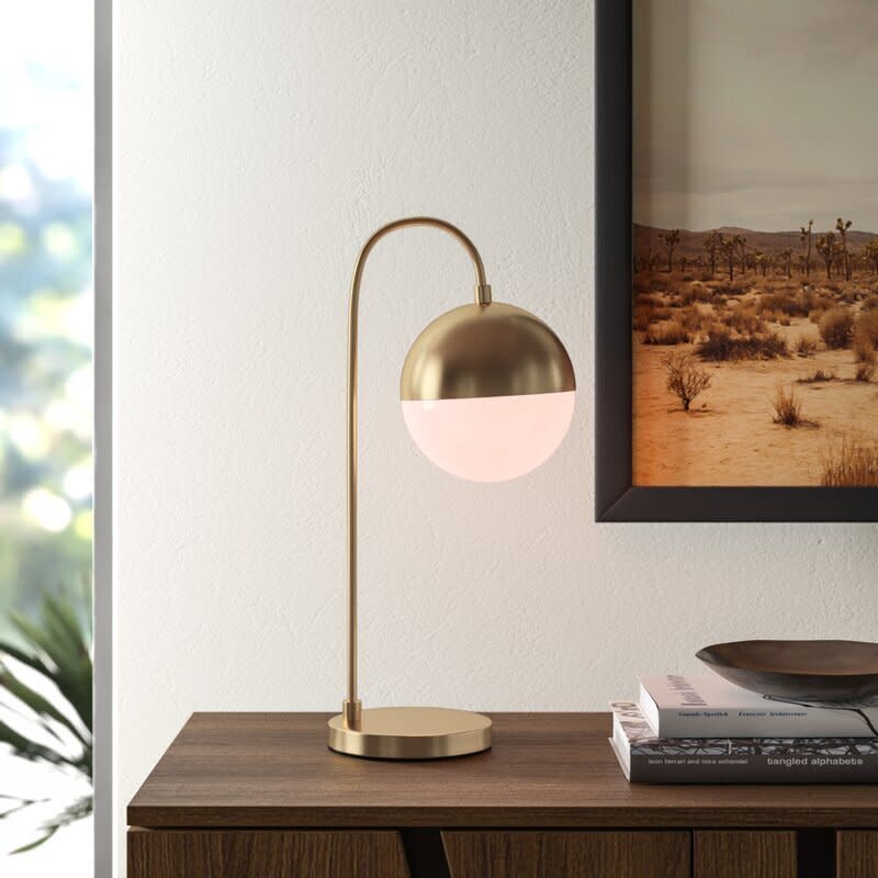 This modern lamp is perfect for those who aren't traditionalists. It features a white acrylic globe shade, round pedestal base and arched arm. And this lamp comes with a 25-watt compact fluorescent bulb. <a href="https://fave.co/2RrwhBl" target="_blank" rel="noopener noreferrer">﻿Find it for $78 at AllModern</a>.