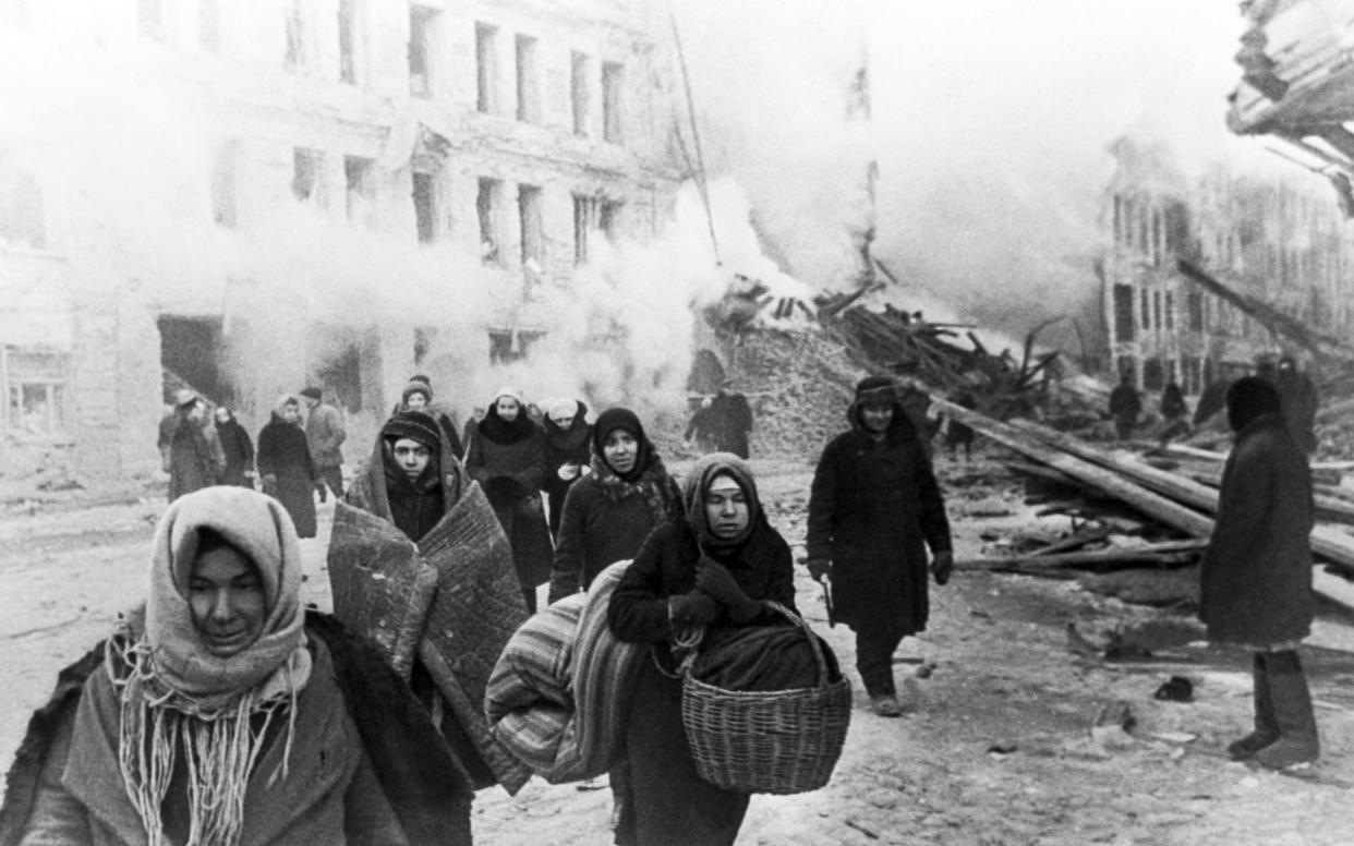 People leave their houses destroyed after German air raids during the Siege of Leningrad on the Eastern Front of World War II - Getty