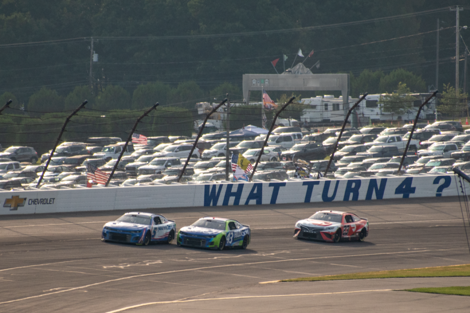 Drivers go through the third turn at Pocono Raceway in the NASCAR Cup Series race in Long Pond on Sunday, July 24, 2022.