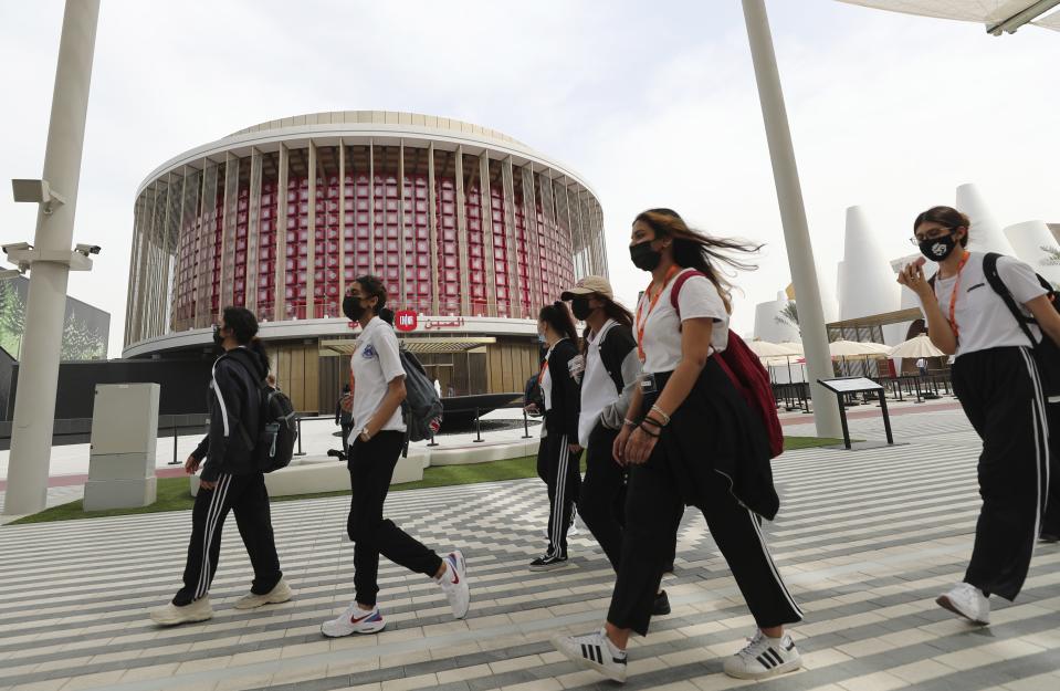 Students pass the Chinese Pavilion at the Dubai Expo 2020, in Dubai, United Arab Emirates, Sunday, Oct, 3, 2021. (AP Photo/Kamran Jebreili)