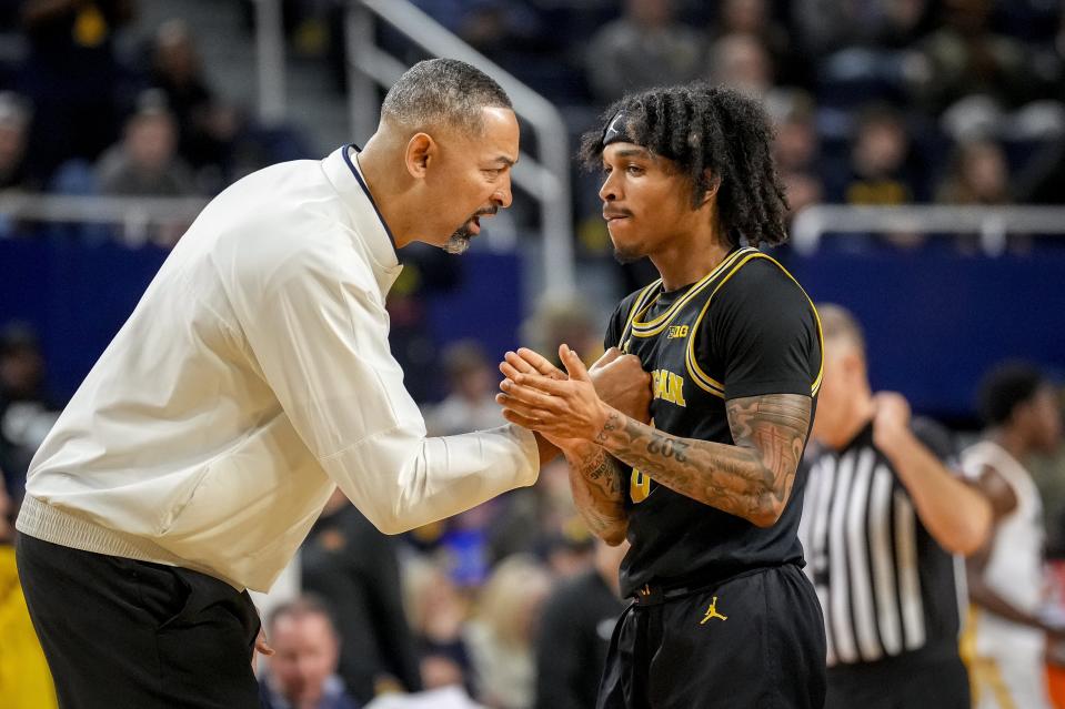 Head coach Juwan Howard of the Michigan Wolverines talks with Dug McDaniel of the Michigan Wolverines during the first half against the Minnesota Golden Gophers at Crisler Center in Ann Arbor on Thursday, Jan. 4, 2024.