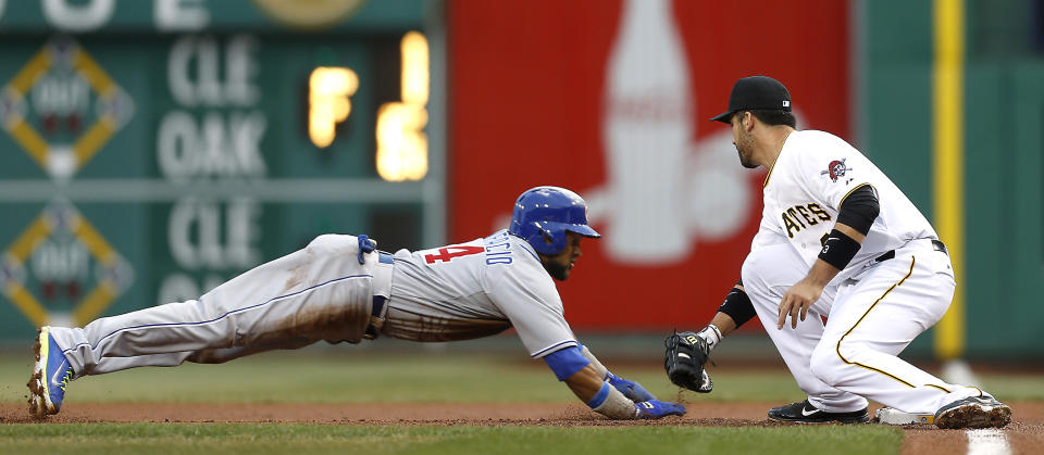 Chicago Cubs' Emilio Bonifacio dives back to first as Pittsburgh Pirates first baseman Travis Ishikawa tags him out during the first inning of a baseball game Wednesday, April 2, 2014, in Pittsburgh. (AP Photo/Keith Srakocic)