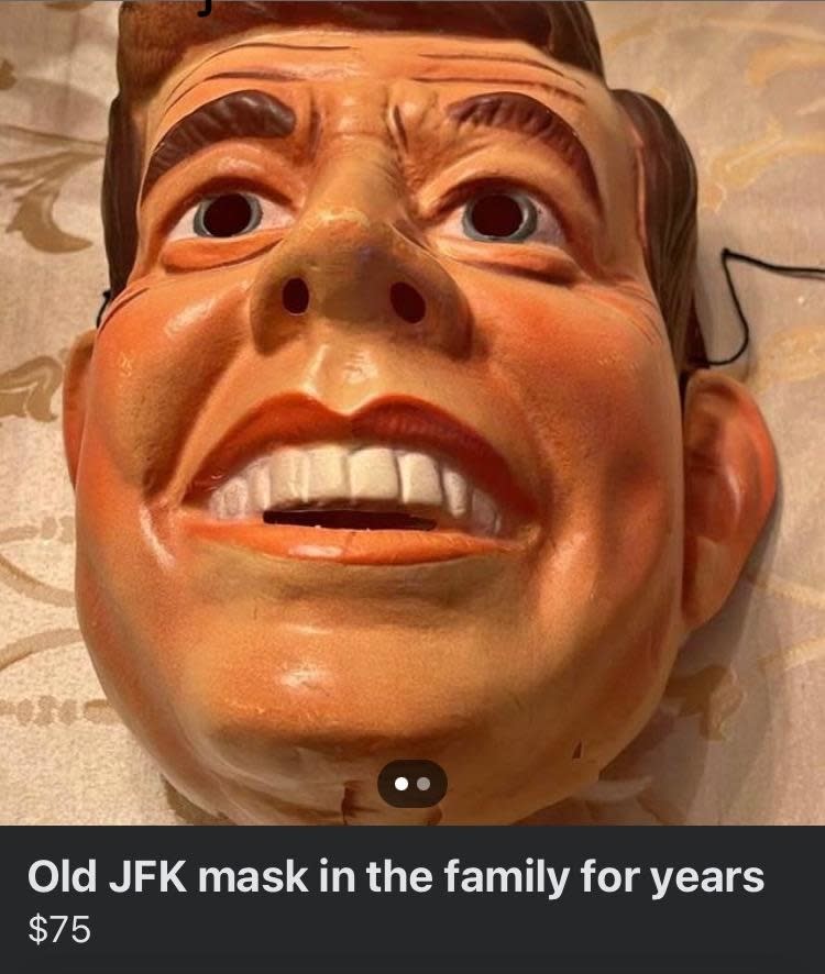 Close-up of an old JFK mask displayed on a patterned surface. Description reads: "Old JFK mask in the family for years. $75"