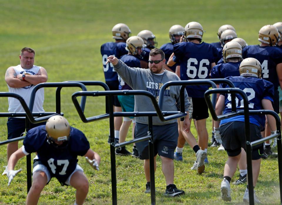 New Prairie football head coach Casey McKim points out instructions during a drill with the offensive linemen in practice Tuesday, August 1, 2023, at New Prairie High School in New Carlisle.