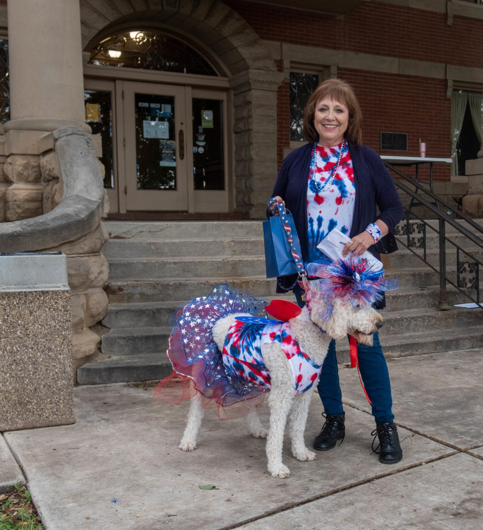Kathy Gallivan shows off best-in-show winner Luka the Labradoodle at Center City's 3rd annual Patriotic Pet Parade Saturday at the Amarillo Community Market in downtown Amarillo.