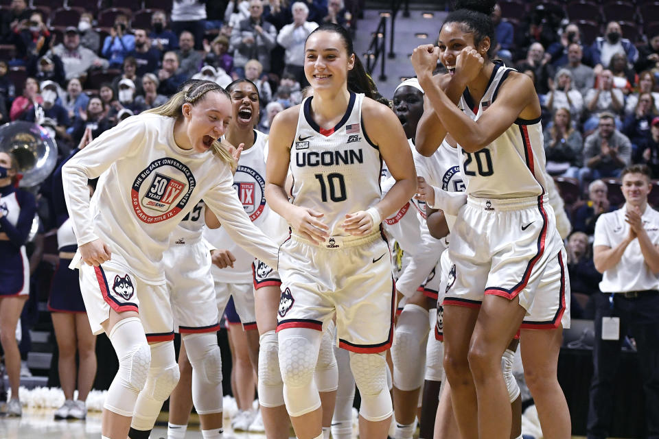 Connecticut's Nika Mühl (10) is congratulated by her teammates as she is awarded Big East Defensive Player of the Year before an NCAA college basketball game against Georgetown in the Big East tournament quarterfinals at Mohegan Sun Arena, Saturday, March 5, 2022, in Uncasville, Conn. (AP Photo/Jessica Hill)