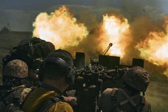 Ukrainian soldiers fire a cannon near Bakhmut, an eastern city where fierce battles against Russian forces have been taking place, in the Donetsk region, Ukraine, Monday, May 15, 2023. (AP Photo/Libkos)