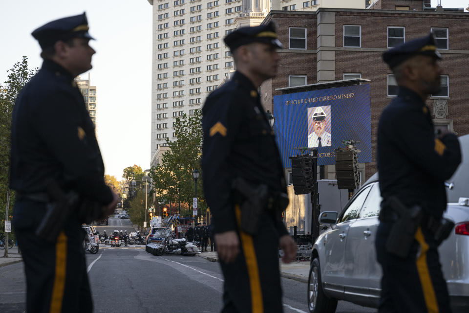 Law enforcement officers attend a viewing for officer Richard Mendez at the Cathedral Basilica of Saints Peter and Paul in Philadelphia, Tuesday, Oct. 24, 2023.Mendez was shot and killed, and a second officer was wounded when they confronted people breaking into a car at Philadelphia International Airport, Thursday, Oct. 12, 2023, police said. (AP Photo/Joe Lamberti)