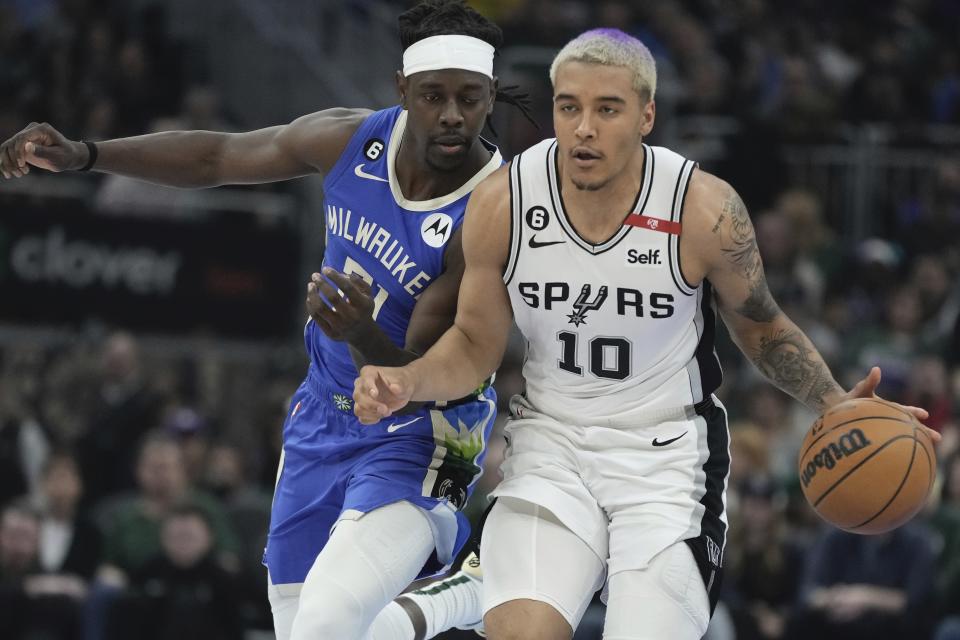 San Antonio Spurs' Jeremy Sochan tries to get past Milwaukee Bucks' Jrue Holiday during the first half of an NBA basketball game Wednesday, March 22, 2023, in Milwaukee. (AP Photo/Morry Gash)