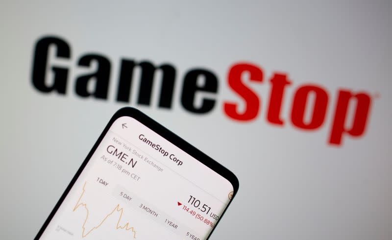 FILE PHOTO: GameStop stock graph is seen in front of the company's logo