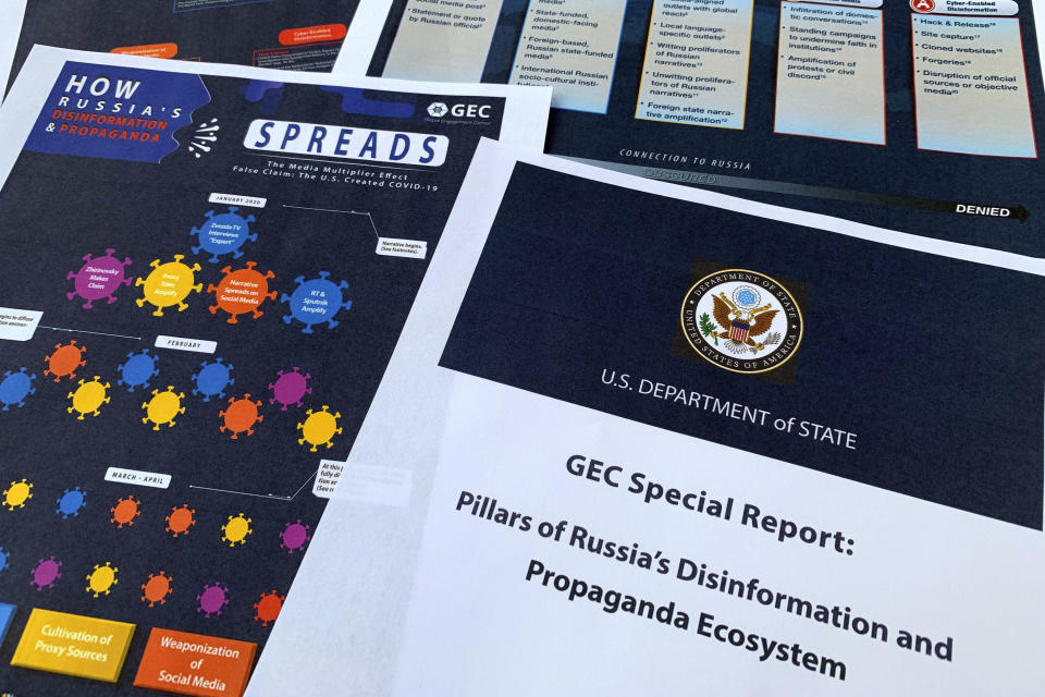 Pages from the U.S. State Department's Global Engagement Center report released on Aug. 5, 2020, are seen in this photo. The State Department says Russia is using a well-developed online operation that includes a loose collection of proxy websites to stir up confusion around the coronavirus by amplifying conspiracy theories and misinformation. The department detailed a Russian-backed misinformation cycle that spreads false information online through state officials and state-funded media reports, by infiltrating U.S. social media conversation, and leveraging a deceptive internet framework of websites. (AP Photo/Jon Elswick)