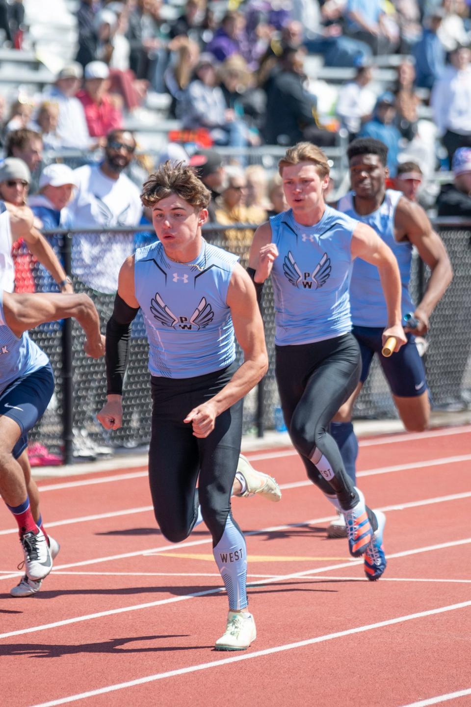 Pueblo West's Gavin Lockett, left, prepares to take the baton from teammate Evan Lujan in the Class 4A 4x100 meter relay during the CHSSA state track and field meet on Saturday, May 21, 2022 at Jeffco Stadium.