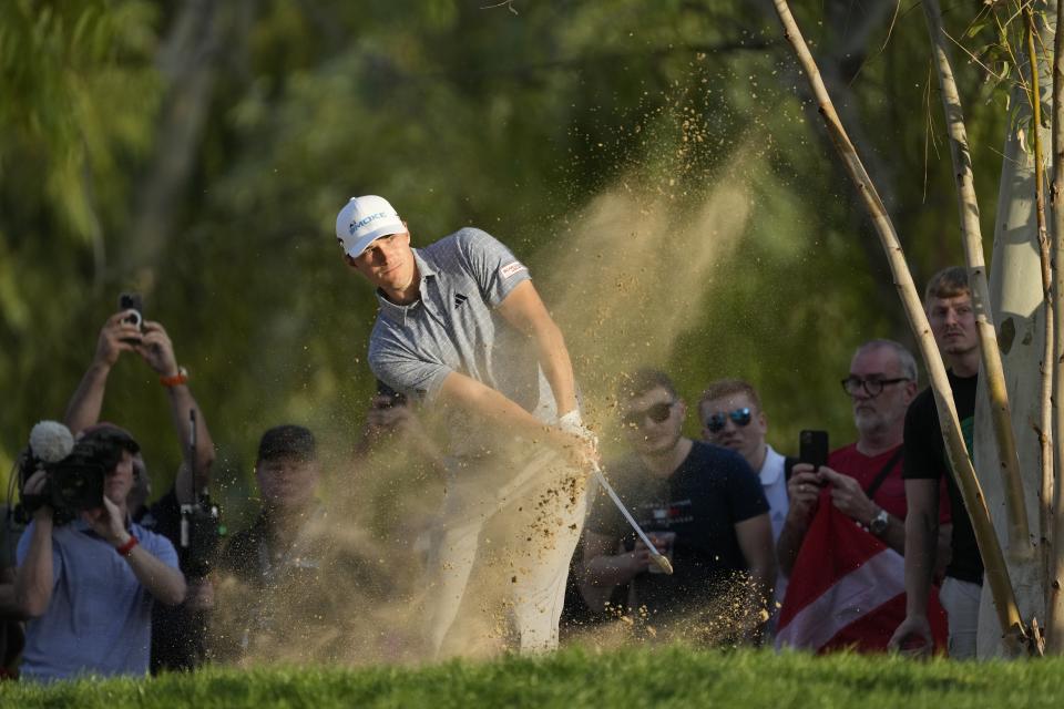 Rasmus Hojgaard of Denmark plays his second shot on the18th hole during the third round of the Hero Dubai Desert Classic golf tournament, in Dubai, United Arab Emirates, Saturday, Jan. 20, 2024. (AP Photo/Kamran Jebreili)