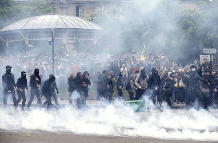 Tear gas fills the air during clashes with French gendarmes during a demonstration in protest of the government's proposed labor law reforms in Paris, France, May 26, 2016. REUTERS/Charles Platiau