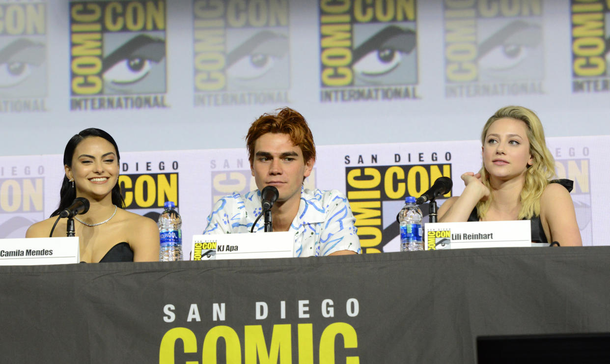 SAN DIEGO, CALIFORNIA - JULY 21: (L-R) Camila Mendes, KJ Apa and Lili Reinhart speak at the "Riverdale" Special Video Presentation and Q&A during 2019 Comic-Con International at San Diego Convention Center on July 21, 2019 in San Diego, California. (Photo by Albert L. Ortega/Getty Images)
