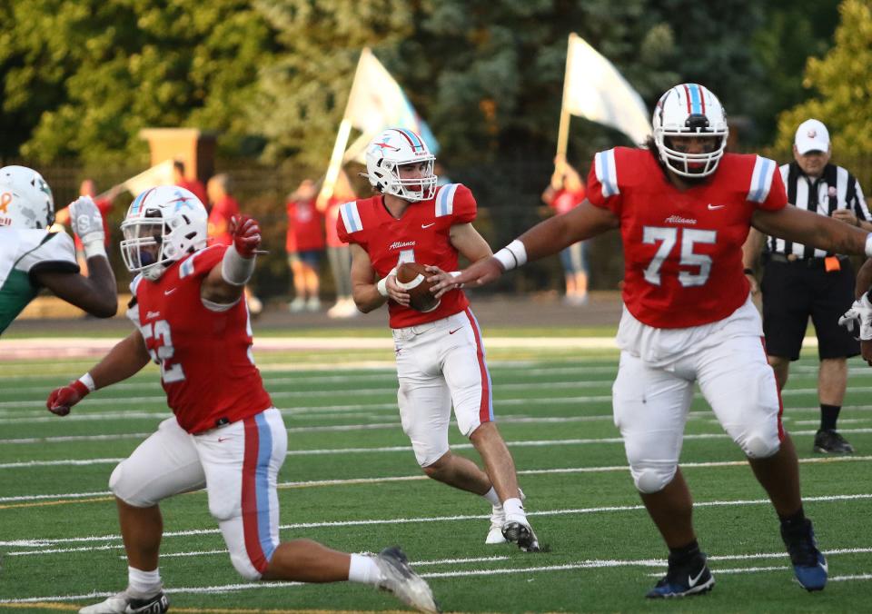 Alliance quarterback Brendan Zurbrugg drops back to pass during their game against Bedford at Kehres Stadium, Friday, September 2, 2022.