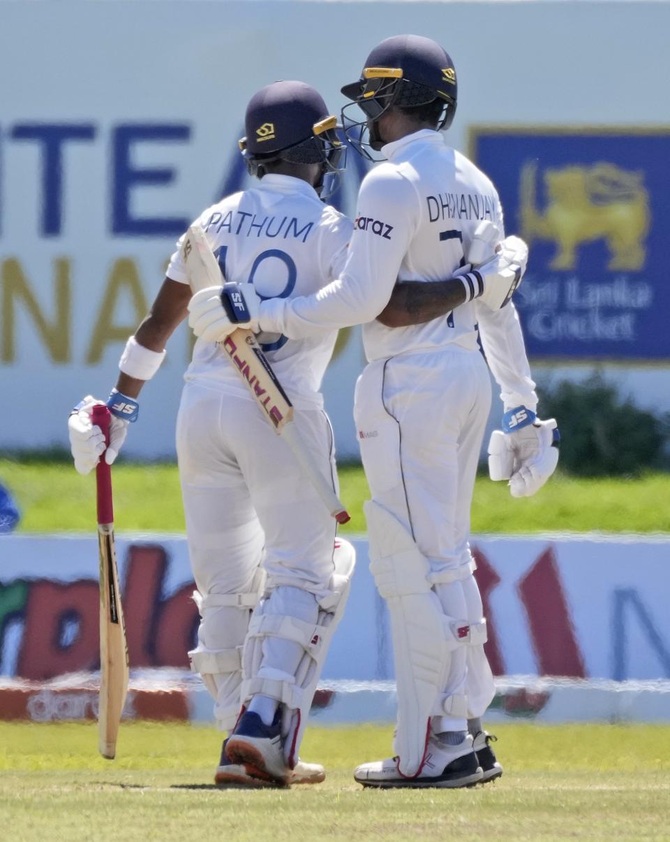 Sri Lankan batsman Dhananjaya de Silva, right, congratulates teammate Pathum Nissanka for scoring a half century during the fourth day of their second test cricket match with West Indies in Galle, Sri Lanka, Thursday, Dec. 2, 2021. (AP Photo/Eranga Jayawardena)