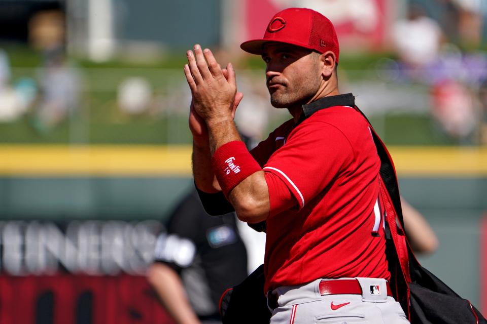 Cincinnati Reds first baseman Joey Votto (19) recognizes the crowd after exiting a spring training baseball game against the Cleveland Guardians, Friday, March 18, 2022, at Goodyear Ballpark Goodyear, Ariz.