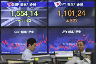 Currency traders work at the foreign exchange dealing room of the KEB Hana Bank headquarters in Seoul, South Korea, Tuesday, Feb. 4, 2020. Shares advanced in Asia on Tuesday, with the Shanghai Composite up 0.2% after a rebound on Wall Street overnight. (AP Photo/Ahn Young-joon)