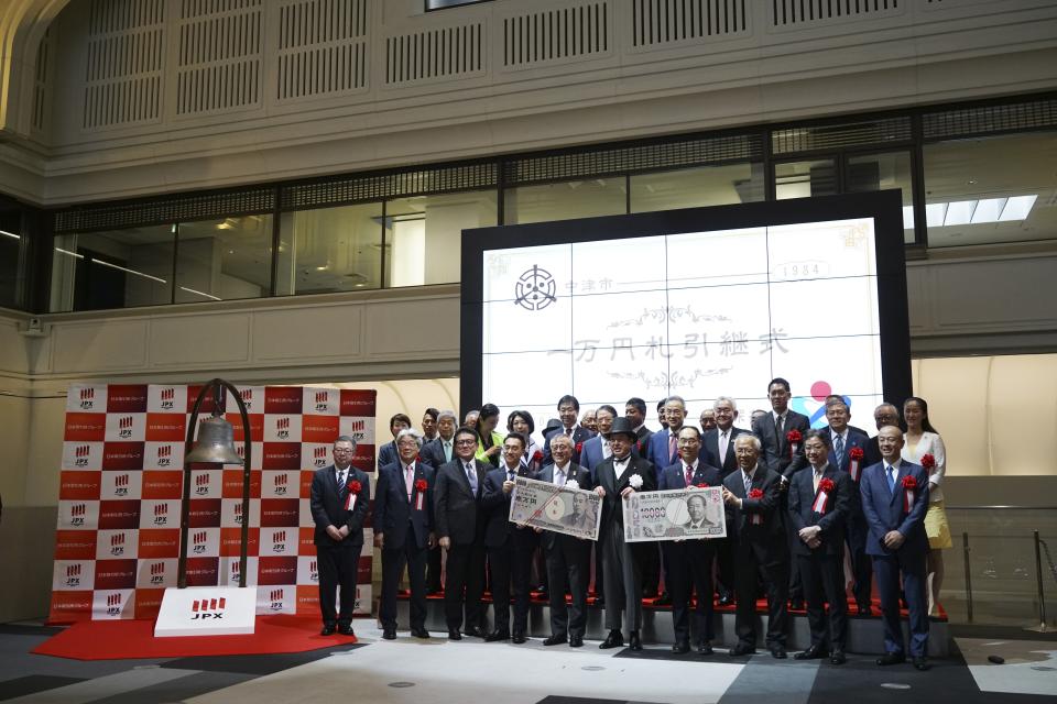 Officials attend the "10,000 Yen Bill Handover Ceremony" at Tokyo Stock Exchange Wednesday, July 3, 2024, in Tokyo. Newly designed banknotes, 10,000 yen (about US$61), 5,000 yen (about US$30) and 1,000 yen (about US$6) went into circulation Wednesday for the first time in 20 years. (AP Photo/Eugene Hoshiko)