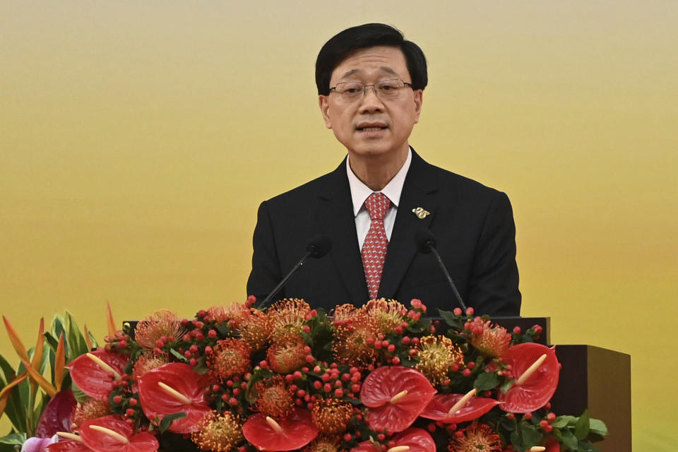 FILE- Hong Kong's Chief Executive John Lee gives a speech following a swearing-in ceremony to inaugurate the city's new government in Hong Kong on July 1, 2022. Hong Kong’s leader announced Friday, Sept. 23, 2022, the city would no longer require incoming travelers to quarantine in designated hotels as the city seeks to open up globally after nearly two years.(Selim Chtayti/Pool Photo via AP, File)