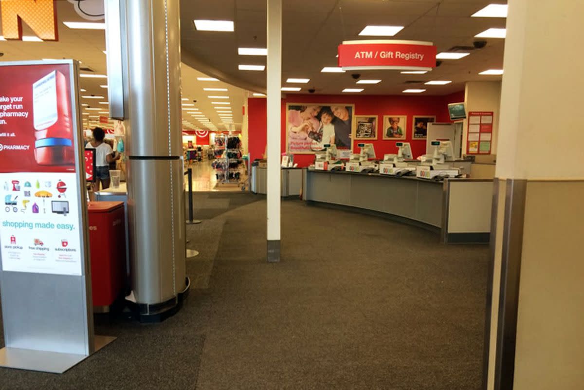 Customer service counter in a Target store, right, clothing aisles left, well lit and clean