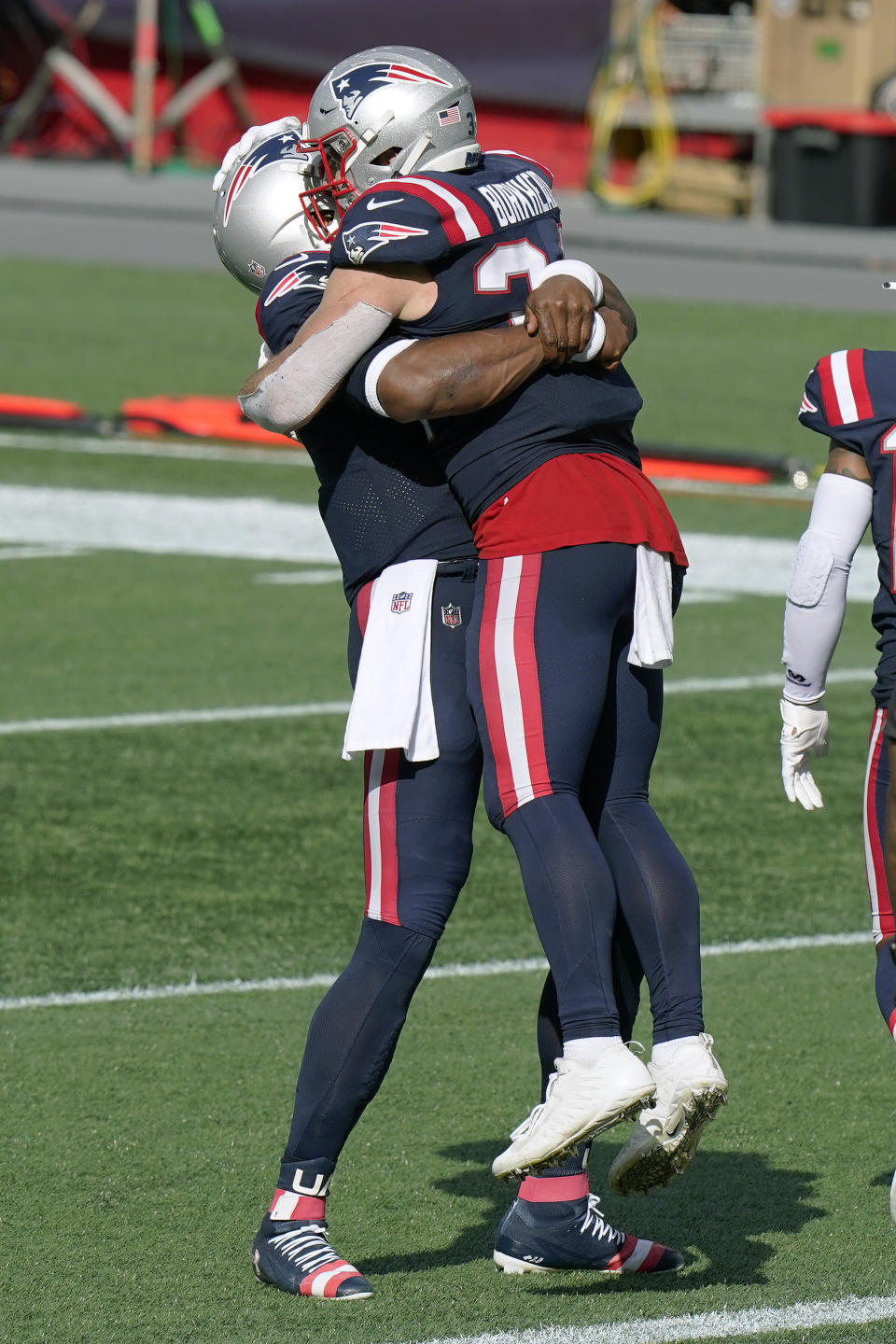 New England Patriots quarterback Cam Newton, left, gives running back Rex Burkhead a lift after Burkhead's touchdown in the second half of an NFL football game against the Las Vegas Raiders, Sunday, Sept. 27, 2020, in Foxborough, Mass. (AP Photo/Steven Senne)