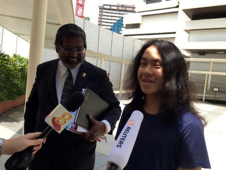 Teen blogger Amos Yee speaks to reporters next to lawyer Nadarajan Kanagavijayan, after hearing his verdict, while leaving the State Courts in Singapore September 29, 2016. REUTERS/Pedja Stanisic