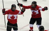 Canada's Marie-Philip Poulin (L) celebrates her gold medal-winning overtime goal against Team USA with teammate Hayley Wickenheiser at the Sochi 2014 Winter Olympic Games February 20, 2014. REUTERS/Laszlo Balogh