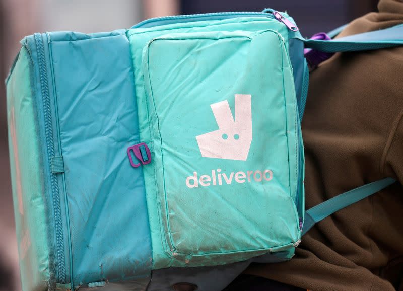 FILE PHOTO: A Deliveroo delivery rider cycles in London