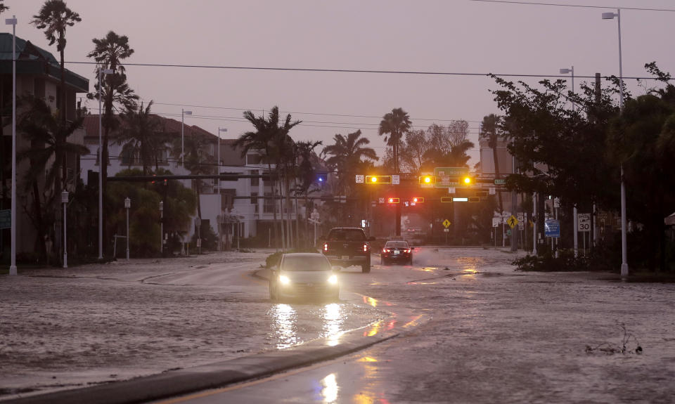 <p><strong>Naples</strong><br> Vehicles drive through a flooded street as Hurricane Irma passes through Naples, Fla., Sept. 10, 2017. (Photo: David Goldman/AP) </p>