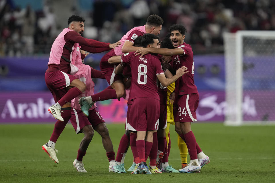 Qatar's players celebrate after teammate Hasan Al Haydos scored the opening goal during the Asian Cup Group A soccer match between Qatar and China at the Khalifa International stadium in Doha, Qatar, Monday, Jan. 22, 2024. (AP Photo/Thanassis Stavrakis)
